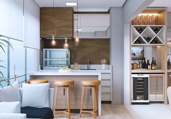 Varanda gourmet pequena integrada ao restante do apartamento; pequeno degrau faz a diferenciação entre os ambientes.